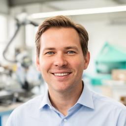 Michael T., CEO portrait in a bright workshop setting